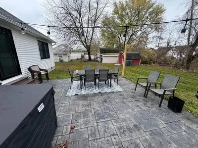 a patio with a table and chairs in a yard at Beck Lake House in Kelleys Island