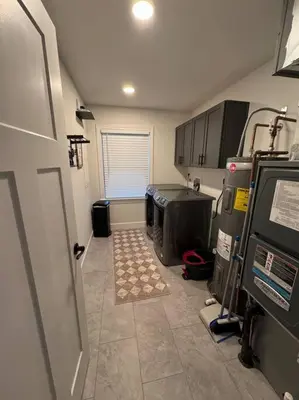 a small room with a kitchen with a door and a rug at Beck Lake House in Kelleys Island