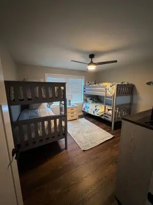 a bedroom with two bunk beds and a ceiling fan at Beck Lake House in Kelleys Island