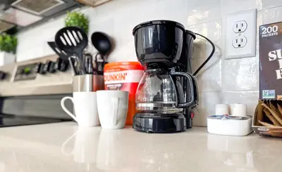 a kitchen counter with a coffee maker on a counter top at Modern & Cozy Downtown Apartment in Cincinnati in Cincinnati