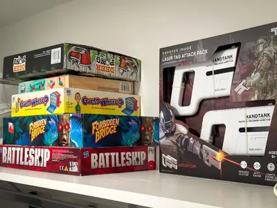 two boxes of games on a shelf at Modern & Cozy Downtown Apartment in Cincinnati in Cincinnati