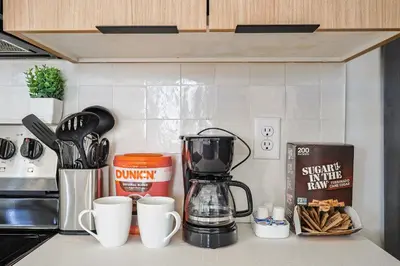 a kitchen counter with a coffee maker and coffee cups at Modern & Cozy Downtown Apartment in Cincinnati in Cincinnati