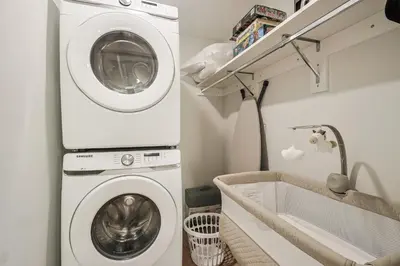 a laundry room with a washing machine and a tub at Modern & Cozy Downtown Apartment in Cincinnati in Cincinnati