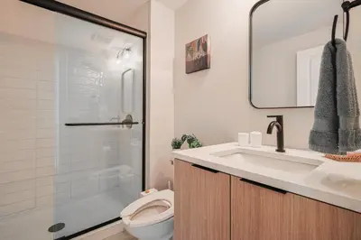 a bathroom with a toilet and a sink and a shower at Modern & Cozy Downtown Apartment in Cincinnati in Cincinnati