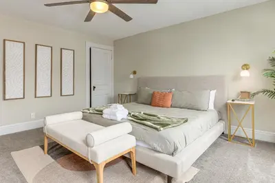 a bedroom with a bed and a ceiling fan at 2 Mi to Dtwn Cincinnati Home with Fenced Yard! in Covington