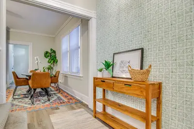 a dining room with a table and chairs and a wall at 2 Mi to Dtwn Cincinnati Home with Fenced Yard! in Covington