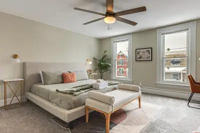 a bedroom with a bed and a ceiling fan at 2 Mi to Dtwn Cincinnati Home with Fenced Yard! in Covington