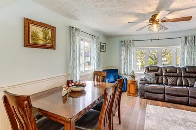 a dining room with a table and a couch at Walk to Sandusky Bay Home with Hot Tub and Fire Pit! in Sandusky