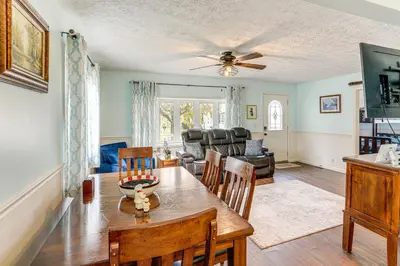 a dining room and living room with a table and chairs at Walk to Sandusky Bay Home with Hot Tub and Fire Pit! in Sandusky