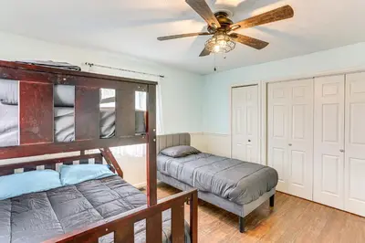 a bedroom with a bed and a ceiling fan at Walk to Sandusky Bay Home with Hot Tub and Fire Pit! in Sandusky