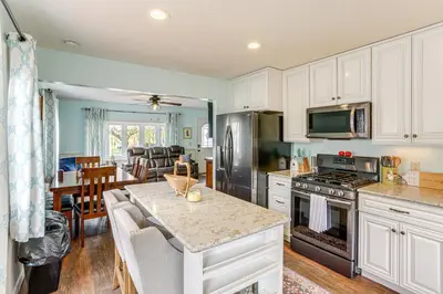 a kitchen with white cabinets and a counter top at Walk to Sandusky Bay Home with Hot Tub and Fire Pit! in Sandusky