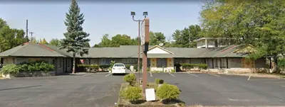 an empty parking lot in front of a building at Holiday Motel in Columbus