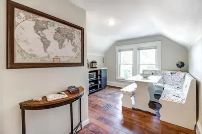 a living room with a table and a map on the wall at Cozy studio near Cleve Clinic Case in Cleveland Heights