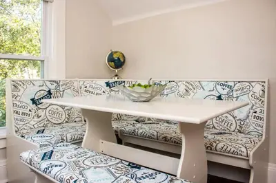 a white table and a bench with a bowl on it at Cozy studio near Cleve Clinic Case in Cleveland Heights
