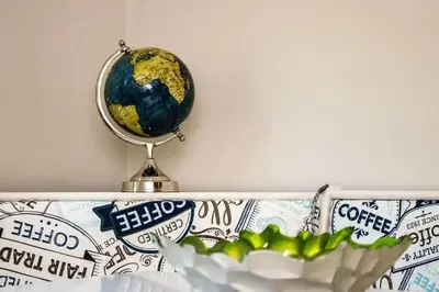 a globe on a shelf next to a bowl of food at Cozy studio near Cleve Clinic Case in Cleveland Heights