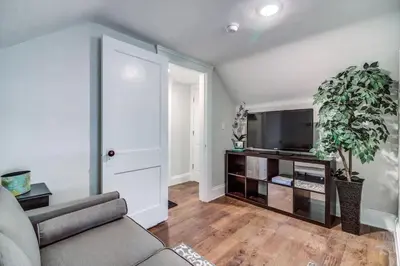 a living room with a couch and a flat screen tv at Cozy studio near Cleve Clinic Case in Cleveland Heights