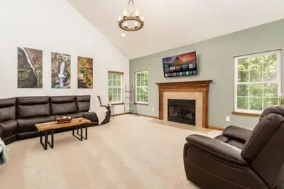 a living room with a couch and a fireplace at Weekend Retreat Hot Tub Game Room Putt Putt in Lancaster