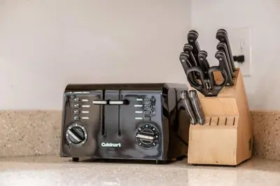 a toaster sitting on top of a counter with knives at Weekend Retreat Hot Tub Game Room Putt Putt in Lancaster