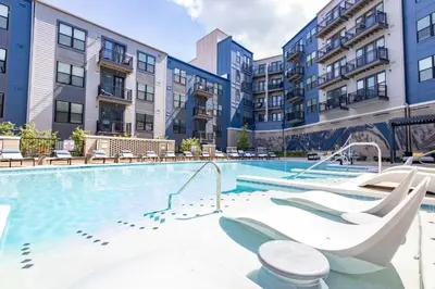 a swimming pool with a slide in a apartment complex at Cozy 6BR 6BA combined Apartments Near Downtown Cincinnati in Cincinnati