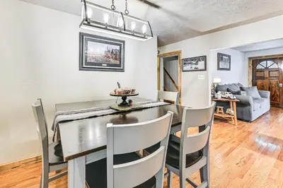a dining room and living room with a table and chairs at On 220 Acres! Hot Tub Haven in West Liberty in West Liberty