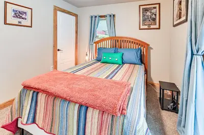 a bedroom with a bed with a wooden headboard at On 220 Acres! Hot Tub Haven in West Liberty in West Liberty
