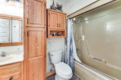 a bathroom with a toilet and a sink and a shower at On 220 Acres! Hot Tub Haven in West Liberty in West Liberty