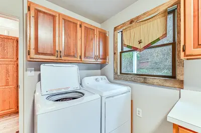 a kitchen with a washer and dryer in a kitchen at On 220 Acres! Hot Tub Haven in West Liberty in West Liberty