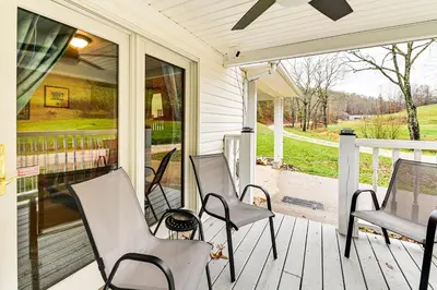 a porch with three chairs and a window at On 220 Acres! Hot Tub Haven in West Liberty in West Liberty