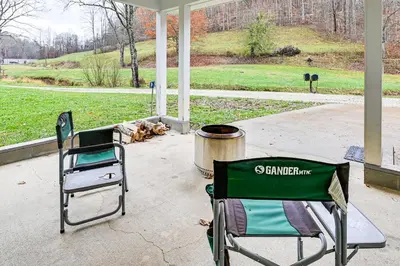 two chairs and a trash can on a porch at On 220 Acres! Hot Tub Haven in West Liberty in West Liberty