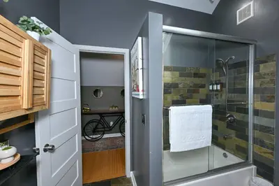 a bathroom with a shower with a glass door at Lux Ohio City Gem in Cleveland