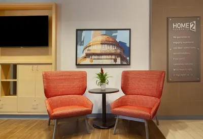 a waiting room with two chairs and a table at Home2 Suites by Hilton Canton in North Canton
