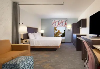 a hotel room with a bed and a television at Home2 Suites by Hilton Canton in North Canton