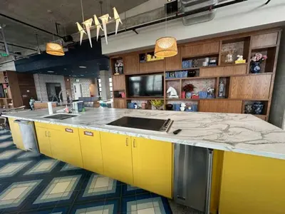 a large kitchen with yellow cabinets and a counter at Brand new 4BR 3BA Combined apartments with city views in Cleveland