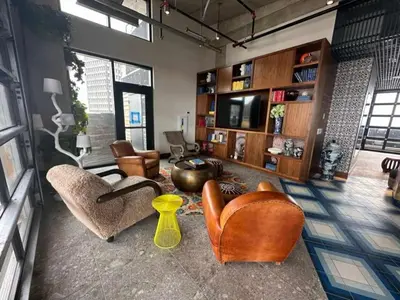 a living room with leather chairs and a television at Brand new 4BR 3BA Combined apartments with city views in Cleveland