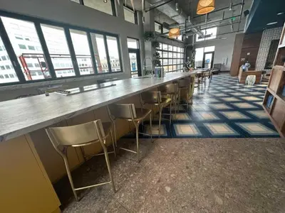 a bar with stools in a room with windows at 7 Brand new combined apartments with city views in Cleveland
