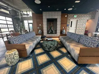 a large living room with couches and a fireplace at 7 Brand new combined apartments with city views in Cleveland