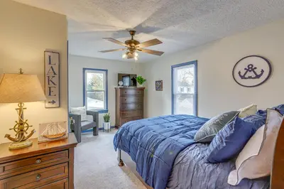 a bedroom with a blue bed and a ceiling fan at Walk to Beach Home with Pool in Vermilion in Vermilion