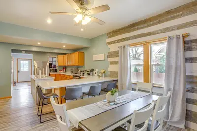 a kitchen and dining room with a table and chairs at Walk to Beach Home with Pool in Vermilion in Vermilion