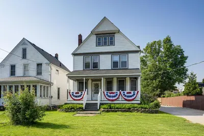 a house with american flags on the front of it at Walk to Beach Home with Pool in Vermilion in Vermilion