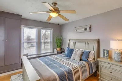 a bedroom with a bed and a ceiling fan at Walk to Beach Home with Pool in Vermilion in Vermilion