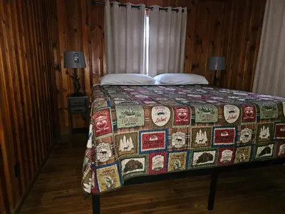 a bedroom with a bed with a quilt on it at The White Stag in Hillsboro