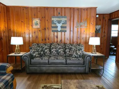 a living room with a couch and two lamps at The White Stag in Hillsboro
