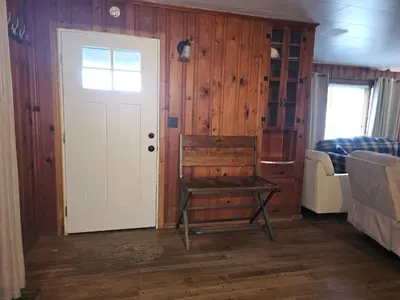 a room with a door and a table and a bed at The White Stag in Hillsboro
