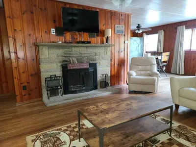a living room with a fireplace and a tv at The White Stag in Hillsboro