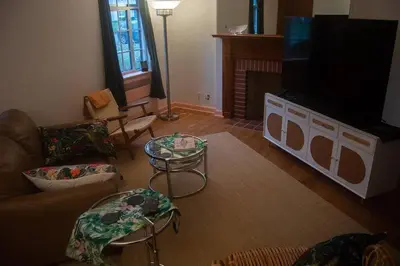 a living room with a couch and a flat screen tv at Tropical Deco in Toledo in Toledo