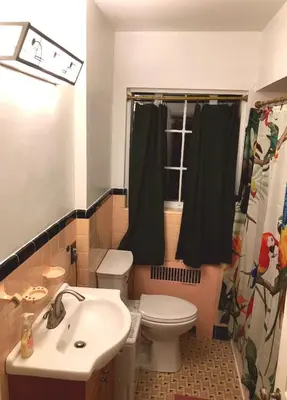 a bathroom with a toilet and a sink at Tropical Deco in Toledo in Toledo