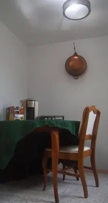a table and a chair with a table and a light at Tropical Deco in Toledo in Toledo