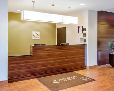 a lobby of a dental office with a reception desk at Sleep Inn & Suites Parkersburg - Mineral Wells in Parkersburg
