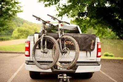 a bike on the back of a white truck at Adventure Hub Biking Hiking Hunting Paddle in Athens