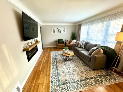 a living room with a couch and a table at Parma Ranch with Hot Tub and Game and Media Room in Parma